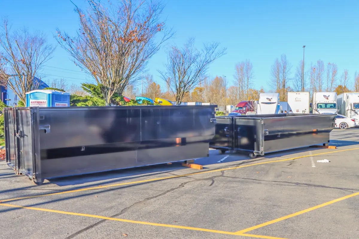 Professional dumpster rental service with roll-off container on residential driveway in Williamsport